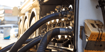 Tanker truck filling up its storage tank at the fuel station. 