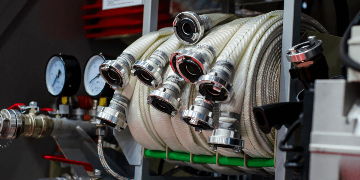 Firehoses on a firetruck displaying their camlock fittings.